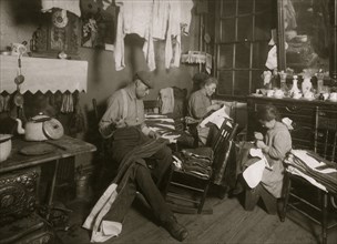 11:30 A.M. Jennie Rizzandi, 9 year old girl, helping mother and father finish garments in a dilapidated tenements, immigrants  1924