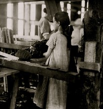 13 yr. old girl "passing" leaves to stringers, tobacco-shed of Hackett farm 1917