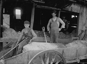 14 year old boy at Heavy Work. Shoveling Ore at Daisy Bell Mine, Aurora,  1910