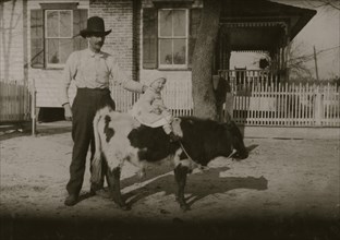 2 "yearlings" belonging to a South Georgia farmer. The former usually gets more attention than the child. John Paulk family 1915