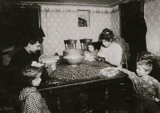 Picking Nuts in squalor and poverty  in a basement tenement apartment 1911