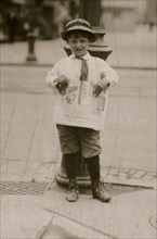 6 yr. old Earle Holt (or Hope) sells papers for a neighbor boy.  1912