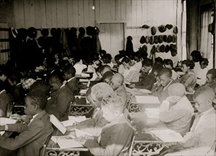 75 Sixth Grade African American children  crowded into 1 small room in an old store building near Black High School, with 1 teacher. 1917