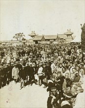A crowd of Japanese soldiers; Chinese coolies in right foreground, Manchuria 1905