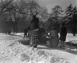 A Ford Tractor cleans snow on DC Street 19245