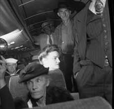 A Greyhound bus trip from Louisville, Kentucky, to Memphis, Tennessee, and the terminals. Passengers standing in aisles on Memphis-Chattanooga Greyhound bus 1943