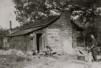 A little log cabin, - relic of the old days, - now occupied by a small family (F.T. Castle) who are gradually giving up farming and depending upon mining and odd jobs.  1921