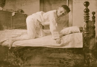 A Young Boy Climbs into Bed 1924