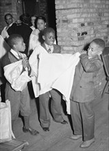African American Boys of children's choir putting on their robes. Chicago, Illinois 1941