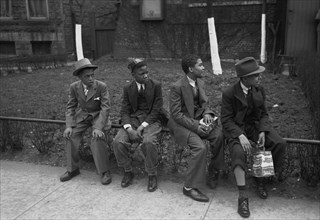 African American Boys waiting outside of Episcopal Church to see the processional, South Side of Chicago, Illinois 1938