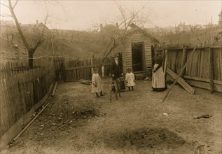 African American family standing in a yard in Georgia 1899