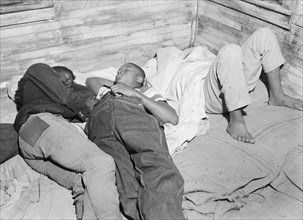 African American in Belcross (vicinity), North Carolina. Migratory farm workers sleeping in a house where thirty-five persons are housed 1940