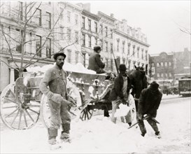 African American men shoveling snow in street, Washington, D.C 1915