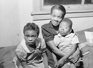 African American Mother and two children. Family is on relief. Chicago, Illinois 1941