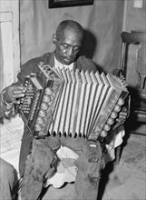 African American Mr. Dyson, aged FSA  borrower plays the accordion.  1941