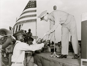 African American receiving a piece of paper, a military award, Tuskegee Army Air Field, Alabama 1943