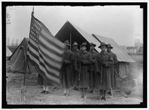 African American soldiers present arms to the Stars & Stripes 1917