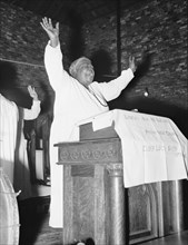 African American Woman Pastor leads her congregation in Prayer 1939