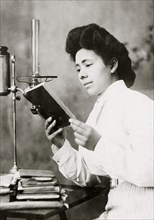 African American Woman reading a book 1899