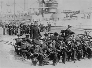 American Sailors of a Battleship form a circle with rifles at the ready 1912