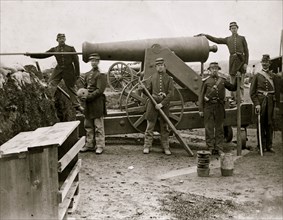 Arlington, Virginia. Soldiers of 4th New York heavy Artillery loading 24-pdr. siege gun on wooden barbette  1862