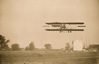 Curtiss-Herring aeroplane, in fligh over field 1909