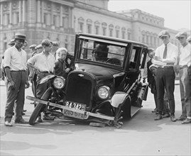Automobile apparently hit the curb and cracked its front axel following which are attracted a group of onlookers 1923