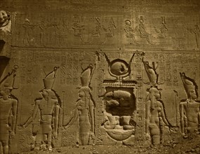 Bas-relief and hieroglyphics cover wall in the Temple of Hathor, located in Dendara, Egypt. 1880
