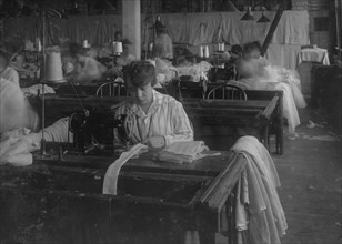 Bessie Blitch, 15 years old. Sewing curtains on machine at Boutwell, Fairclough & Gold, 274 Summer Street Extension. 1917