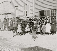 Black children outside of schoolhouse 1889