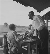Black waiter in Hertzog's, seafood restaurant along the waterfront. Washington, D.C. 1941