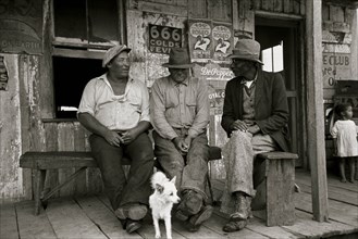 Blackes talking on porch of small store near Jeanerette, Louisiana 1938