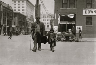 Blind man and his youthful guide 1917