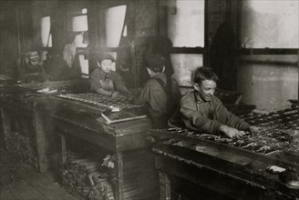 Boys "linking" bed-springs. 14 and 15 years old. 1917