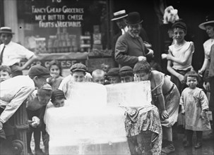 Boys Licking blocks of ice on hot day 1913
