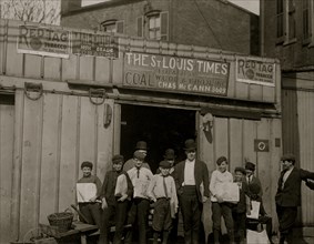 Boys wait outside of a Coal Shed Office that also serves as a depot for the newsboys to pickup their papers i.e. the St. Louis Times 1910
