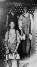 Boys Working in a Cannery, Indianapolis, Unloading freight cars full of new tomato cans 1908