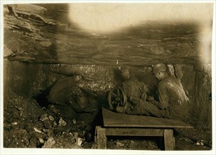 Brown Mine. Man digging coal by machinery low ceiling: 1908
