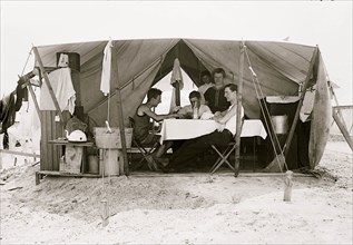 Card game in tent, Tent City, on beach, Rockaway, N.Y.  1910