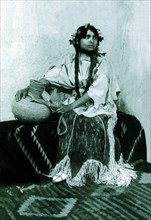 Taos Woman Seated With Water Jug