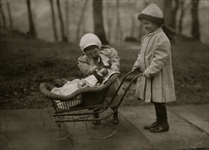 Children playing with Campbell Kid dolls. 1912