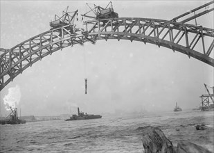 Completing the Hell Gate Railroad Bridge over the East River connecting Queens with Manhattan 1915