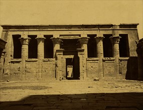 Courtyard and temple with columns connected by panels; Temple of Edfu 1880