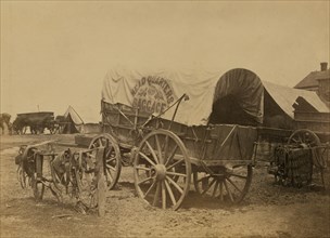 Covered wagon for "Headquarters baggage" and saddlery, probably a Civil War military camp 1863