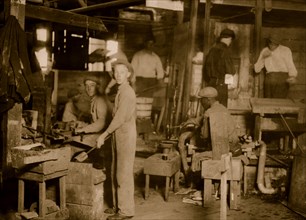 Cumberland Glass Works, Bridgeton, N.J. A young "holding-mold boy" is seen, dimly, in middle distance to left of centre. 1909
