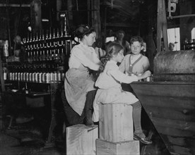 8 year old works in Ross' canneries. She helps at the capping machine, but is not able to "keep up." 1911
