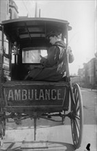 Dr. Elizabeth Bruyn sits in the rear of her Horse Drawn Ambulance 1911