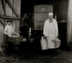 Loading Mill and other Dairy products from the farm into the wagon driven by a young man 1916
