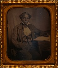 Edward Morris, three-quarter length portrait, full face, seated at desk 1857