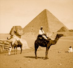 Egypt, Great Pyramid, sphinx, man on camel 1910